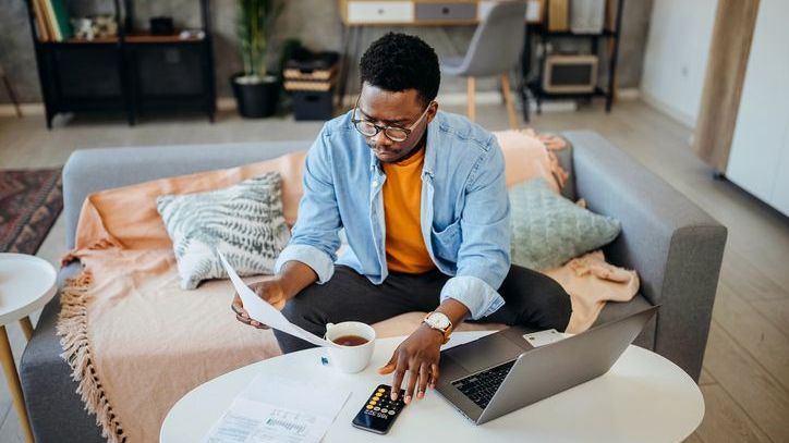 A man calculates how much he'll need to pay each month as part of his tax repayment plan.